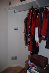 walk-in robe with clothes hanging